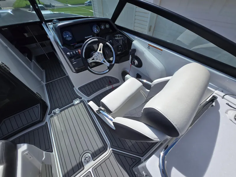 Slide: The Image of Interior of a 2021 Monterey M-65 boat with modern dashboard and seating. - 12