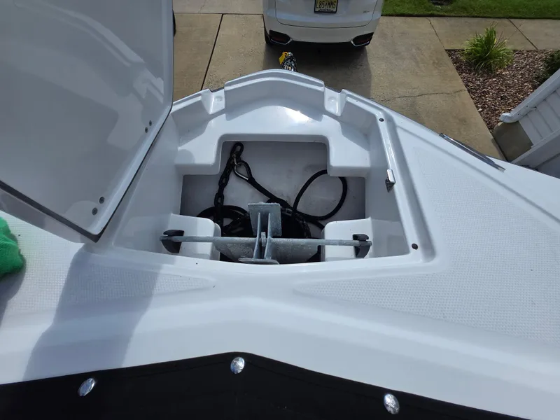 Slide: The Image of Open anchor compartment on a 2021 Monterey M-65 boat, showing anchor and chain storage. - 16