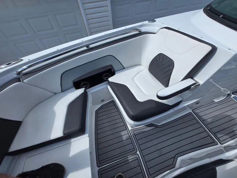 Slide: The Image of Interior of a 2021 Monterey M-65 boat featuring sleek white and black seating. - 20