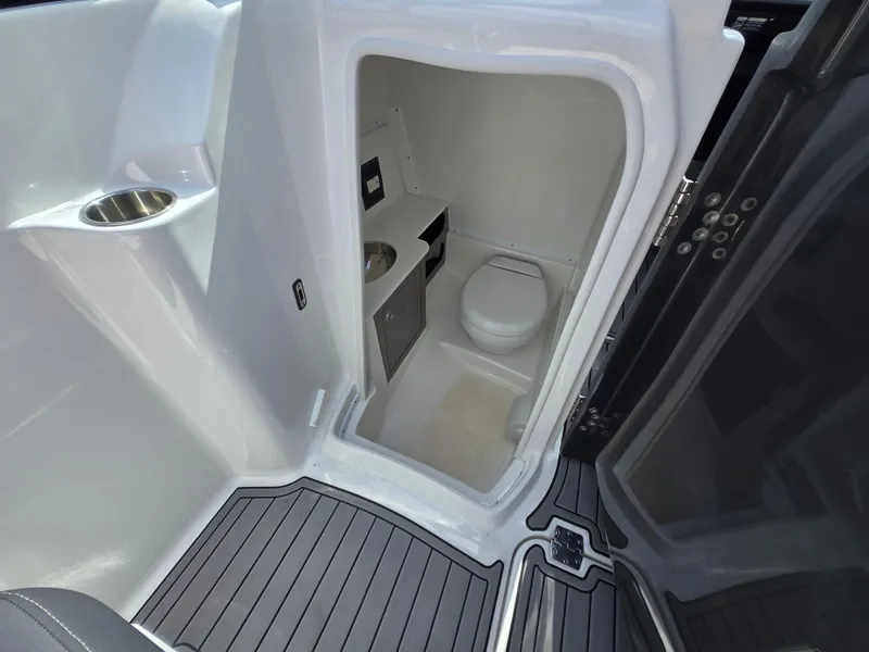 Slide: The Image of Compact bathroom in 2021 Monterey M-65 boat, featuring toilet and sink. - 28