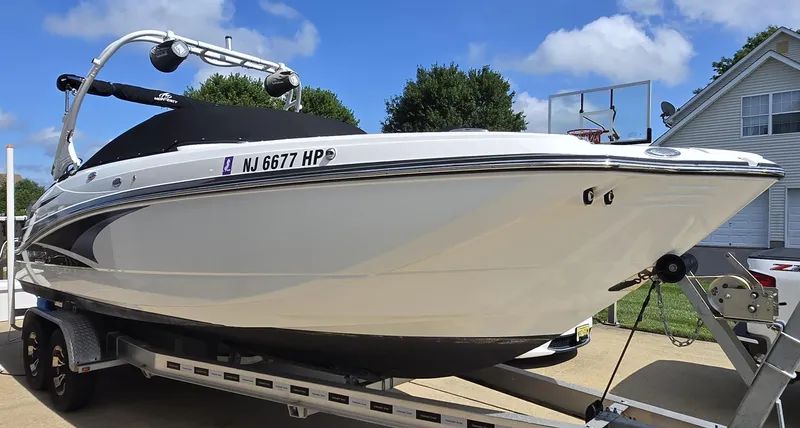 Slide: The Image of 2021 Monterey M-65 boat on trailer, parked in driveway under blue sky. - 5