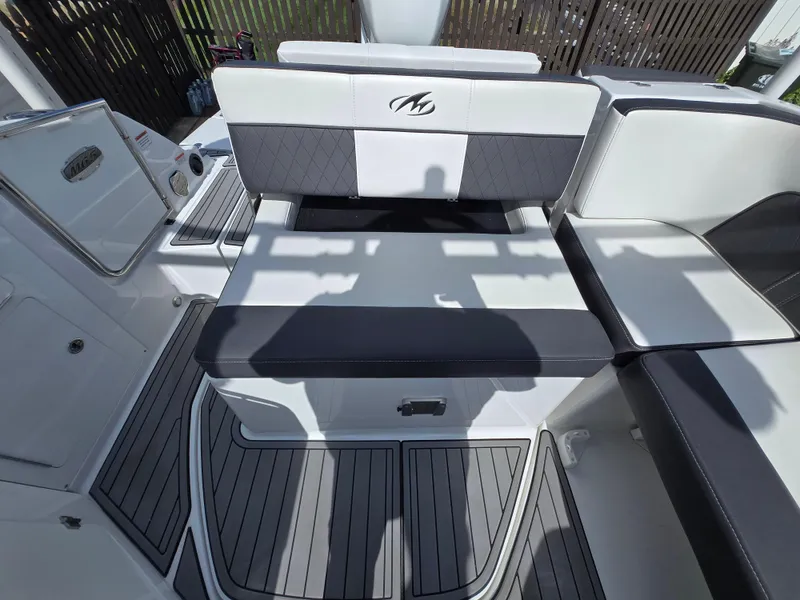 Slide: The Image of 2021 Monterey M-65 boat interior with cushioned seating and sleek design. - 9