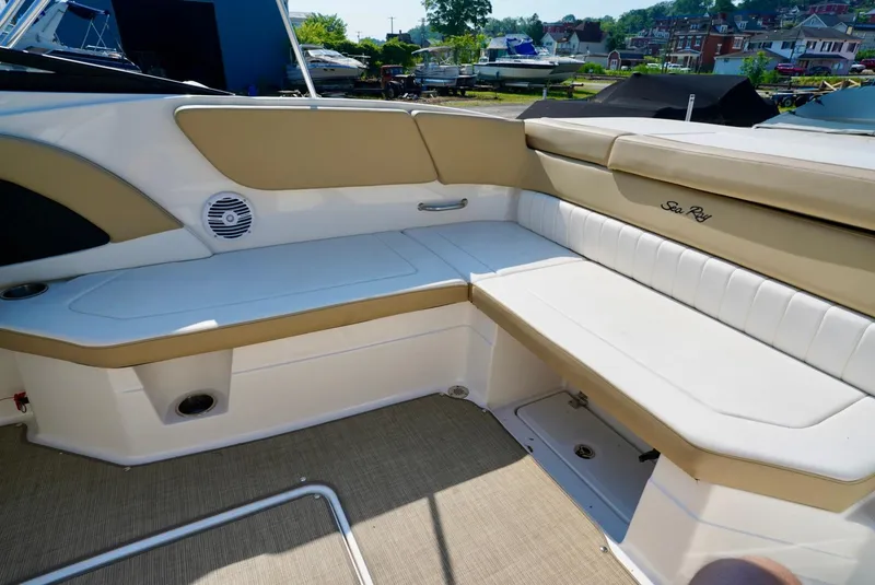 Slide: The Image of 2018 Sea Ray SPX 230 boat interior with beige and white seating. - 13