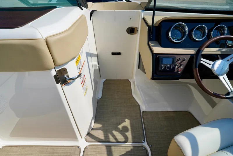 Slide: The Image of Interior view of 2018 Sea Ray SPX 230 boat cockpit with steering wheel and dashboard. - 15