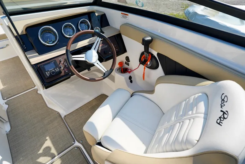 Slide: The Image of 2018 Sea Ray SPX 230 boat interior with steering wheel and dashboard controls. - 16