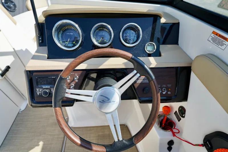Slide: The Image of Steering wheel and dashboard of 2018 Sea Ray SPX 230 boat. - 17