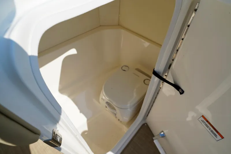 Slide: The Image of Interior view of 2018 Sea Ray SPX 230 boat's compact bathroom area. - 19