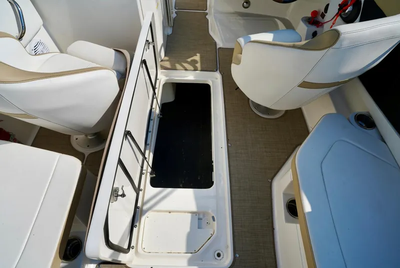 Slide: The Image of 2018 Sea Ray SPX 230 boat interior with open storage compartment and seating. - 21