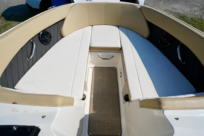 Slide: The Image of 2018 Sea Ray SPX 230 boat interior with beige seating and speaker system. - 23