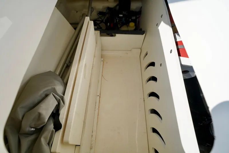 Slide: The Image of Storage compartment of 2018 Sea Ray SPX 230 boat, featuring organized space and equipment. - 24