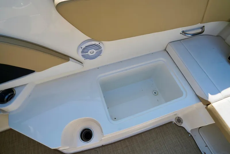 Slide: The Image of Interior of 2018 Sea Ray SPX 230 boat showing storage compartment and seating area. - 27