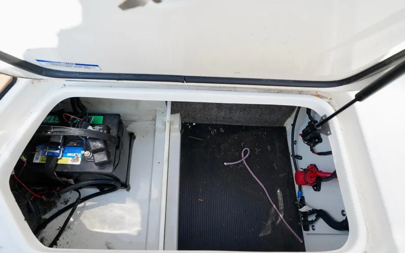Slide: The Image of Battery compartment of a 2018 Sea Ray SPX 230 boat, showing wiring and components. - 29