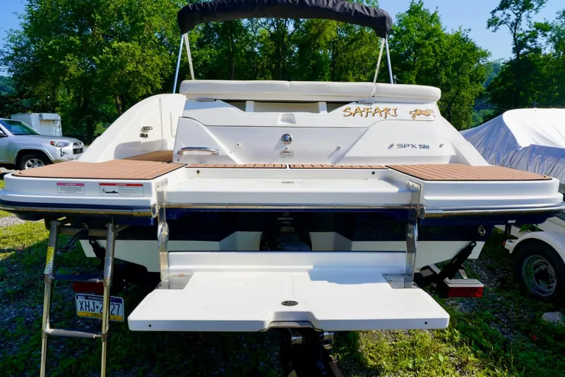 Slide: The Image of 2018 Sea Ray SPX 230 boat with swim platform and ladder, parked outdoors. - 4