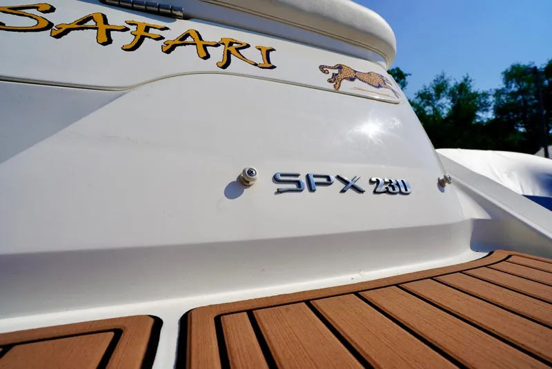 Slide: The Image of 2018 Sea Ray SPX 230 boat with teak deck and "Safari" branding. - 5