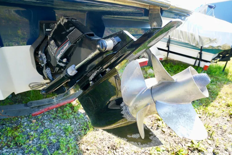 Slide: The Image of 2018 Sea Ray SPX 230 boat with MerCruiser outdrive and propeller, parked on grass. - 7