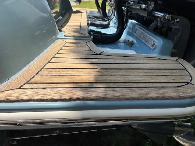 Slide: The Image of 2018 Scout 355 LXF boat on trailer, surrounded by trees. - 12