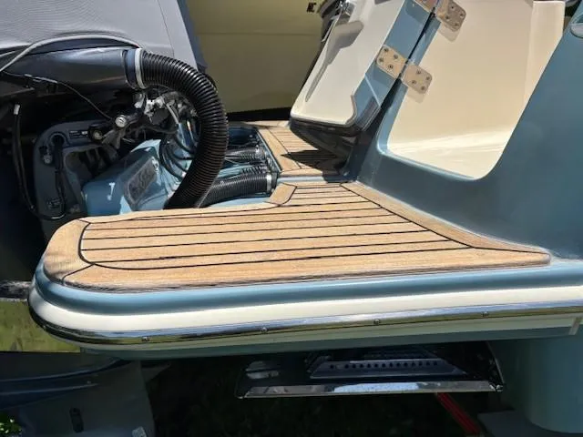 Slide: The Image of 2018 Scout 355 LXF boat on trailer, parked outdoors. - 17