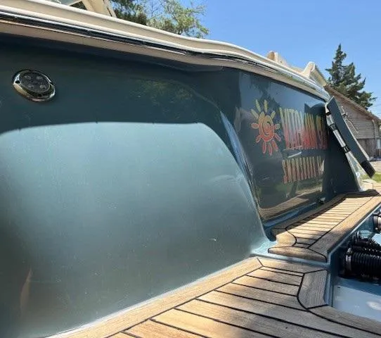 Slide: The Image of Trailer with Scout 355 LXF boat, 2018 model, on a road with damaged tires. - 19