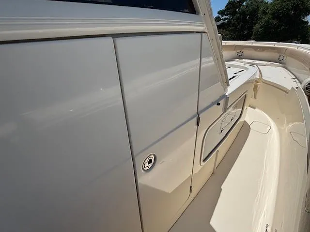 Slide: The Image of 2018 Scout 355 LXF boat with teak swim platform and engine details. - 21