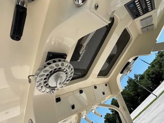 Slide: The Image of 2018 Scout 355 LXF boat with wooden deck and custom graphics. - 23