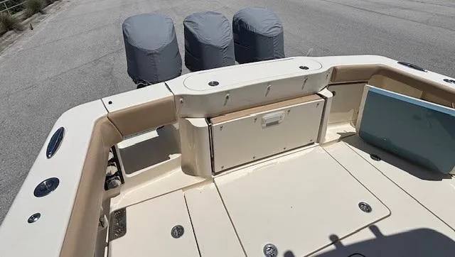 Slide: The Image of 2018 Scout 355 LXF boat seats with beige upholstery and scenic background. - 25