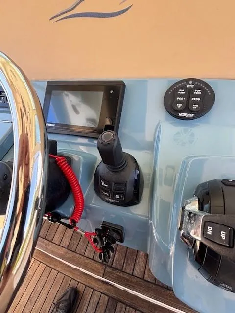 Slide: The Image of 2018 Scout 355 LXF boat deck and side view, showcasing sleek design and craftsmanship. - 27