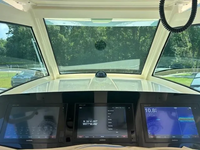 Slide: The Image of Storage compartment on a 2018 Scout 355 LXF boat with cleaning supplies and equipment. - 28