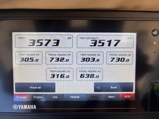 Slide: The Image of 2018 Scout 355 LXF boat helm with steering wheel and control panel. - 30