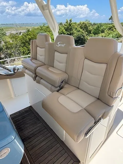 Slide: The Image of 2018 Scout 355 LXF boat with beige seating and sleek design. - 40