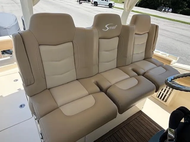 Slide: The Image of 2018 Scout 355 LXF boat with beige cushioned seating in the bow area. - 41