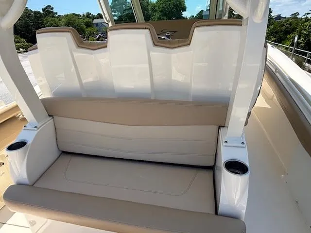 Slide: The Image of Storage compartment of a 2018 Scout 355 LXF boat with life jackets inside. - 42