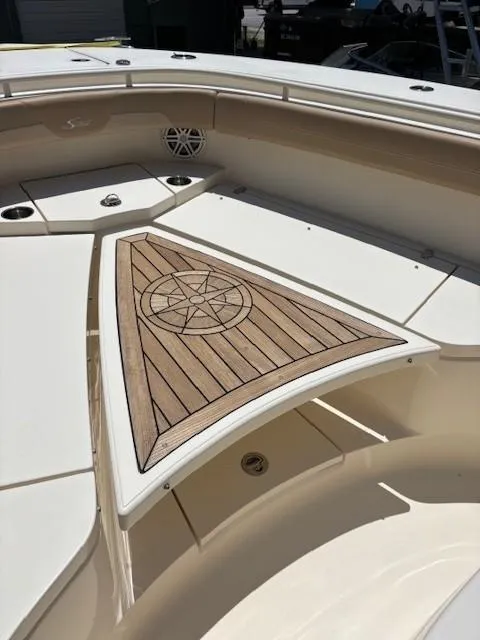 Slide: The Image of 2018 Scout 355 LXF boat with open storage compartment and red life jackets. - 43