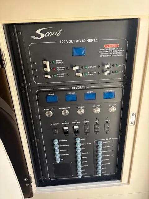 Slide: The Image of Open storage compartment on 2018 Scout 355 LXF boat, showing interior details. - 48