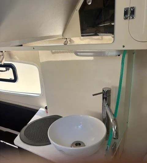 Slide: The Image of 2018 Scout 355 LXF boat interior with cushioned seating area. - 52