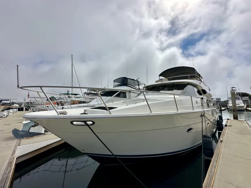 Slide: The Image of 2004 Meridian 580 Pilothouse yacht docked at marina under cloudy sky. - 20