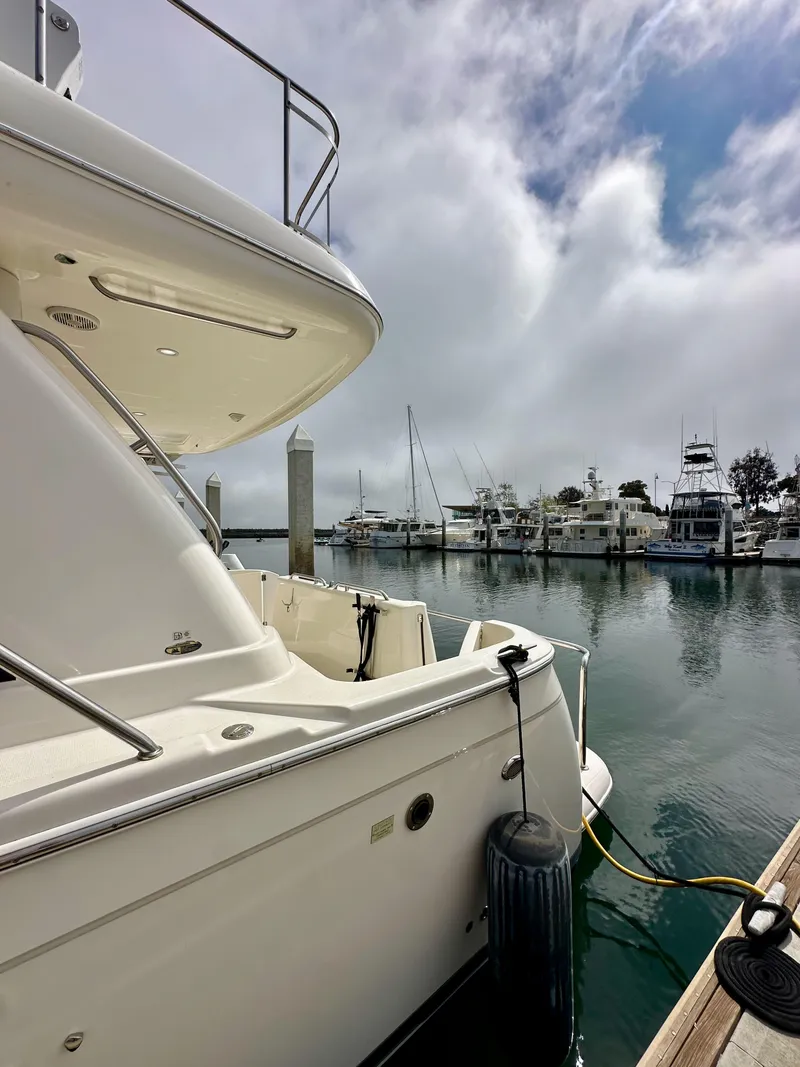 Slide: The Image of 2004 Meridian 580 Pilothouse yacht docked at a marina under cloudy skies. - 23