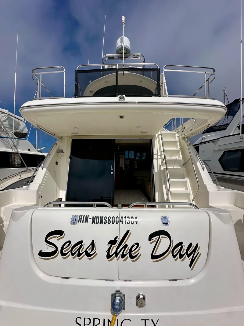 Slide: The Image of 2004 Meridian 580 Pilothouse yacht, "Seas the Day," docked with clear sky background. - 25