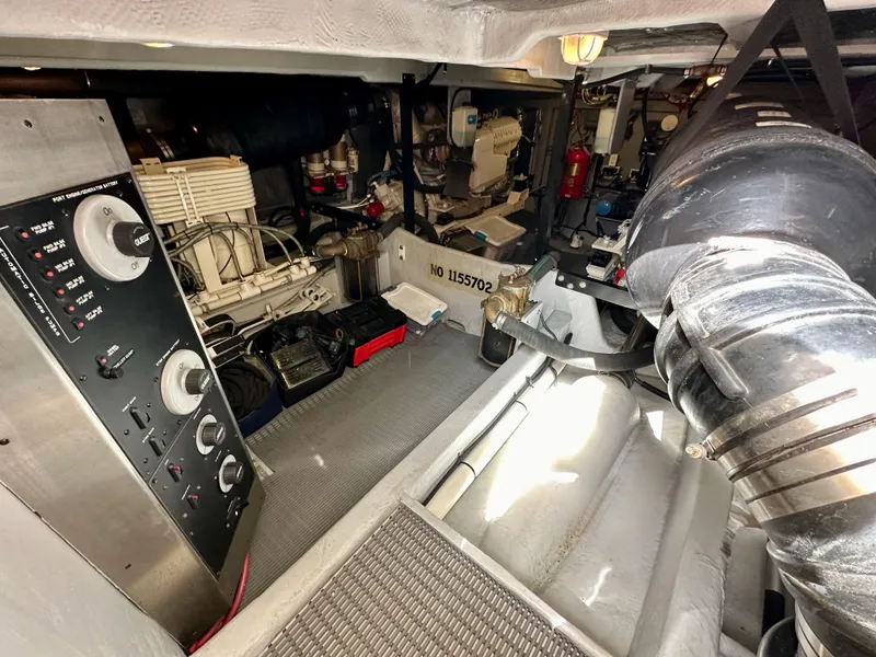 Slide: The Image of Engine room of 2004 Meridian 580 Pilothouse yacht, showcasing mechanical components and control panel. - 34
