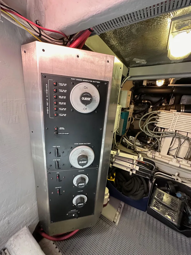 Slide: The Image of Control panel in a 2004 Meridian 580 Pilothouse engine room, featuring switches and wiring. - 35