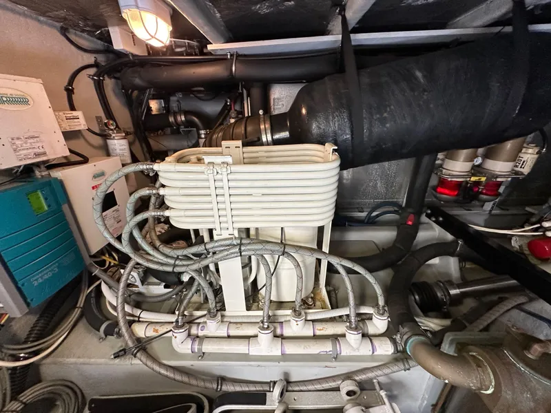 Slide: The Image of Engine room of 2004 Meridian 580 Pilothouse with complex piping and machinery. - 37
