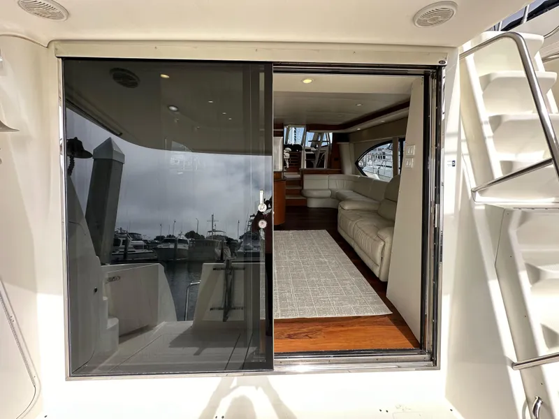 Slide: The Image of 2004 Meridian 580 Pilothouse yacht interior with sliding glass door and luxurious seating. - 47
