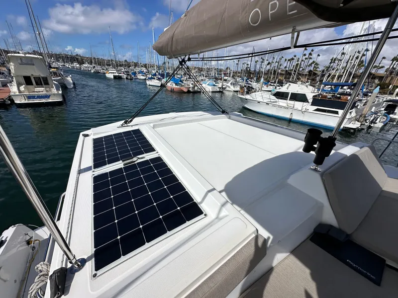 Slide: The Image of 2023 Bali 4.2 yacht with solar panels docked in a marina. - 16