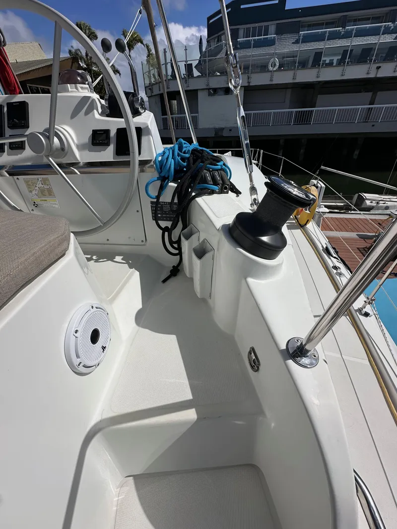 Slide: The Image of 2023 Bali 4.2 yacht deck with steering wheel and winch, docked at marina. - 19
