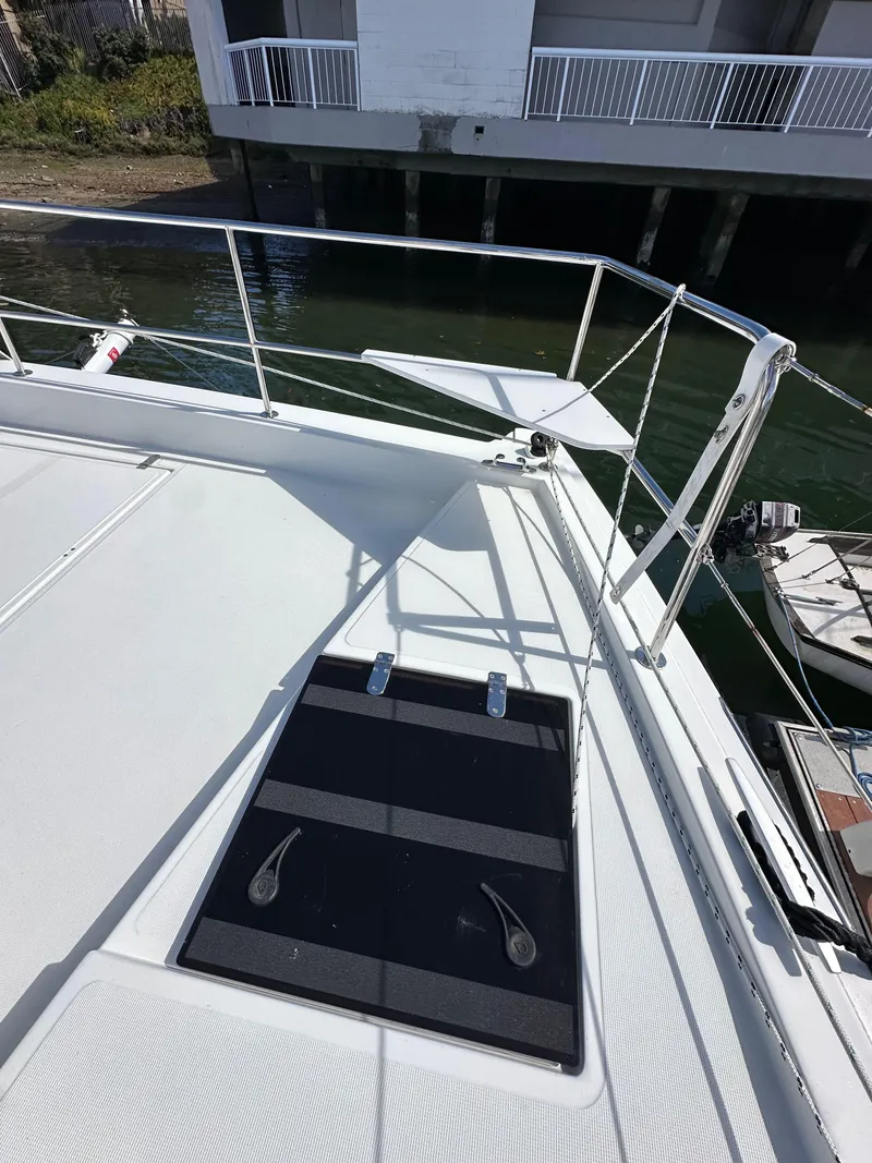 Slide: The Image of 2023 Bali 4.2 yacht deck with railing and docked boat in background. - 22