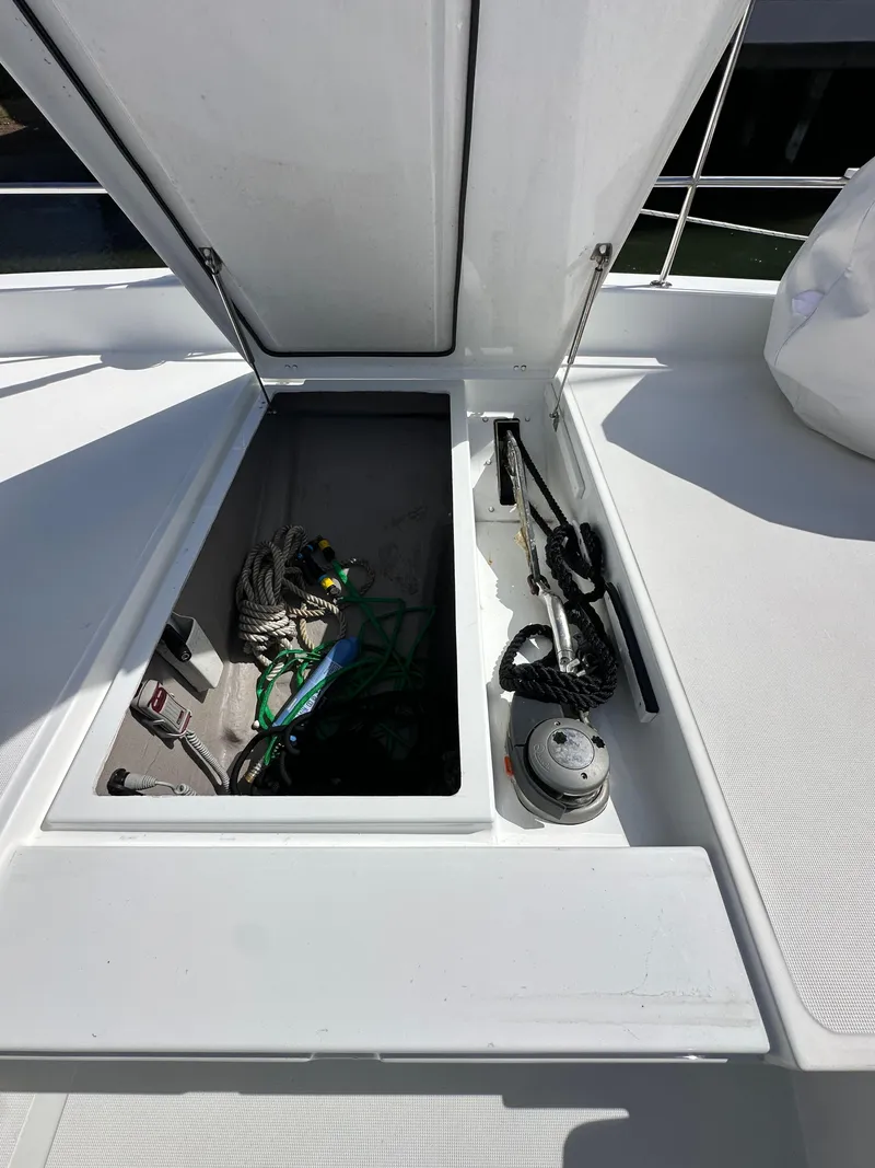 Slide: The Image of Open storage compartment on 2023 Bali 4.2 yacht deck with ropes and equipment. - 27