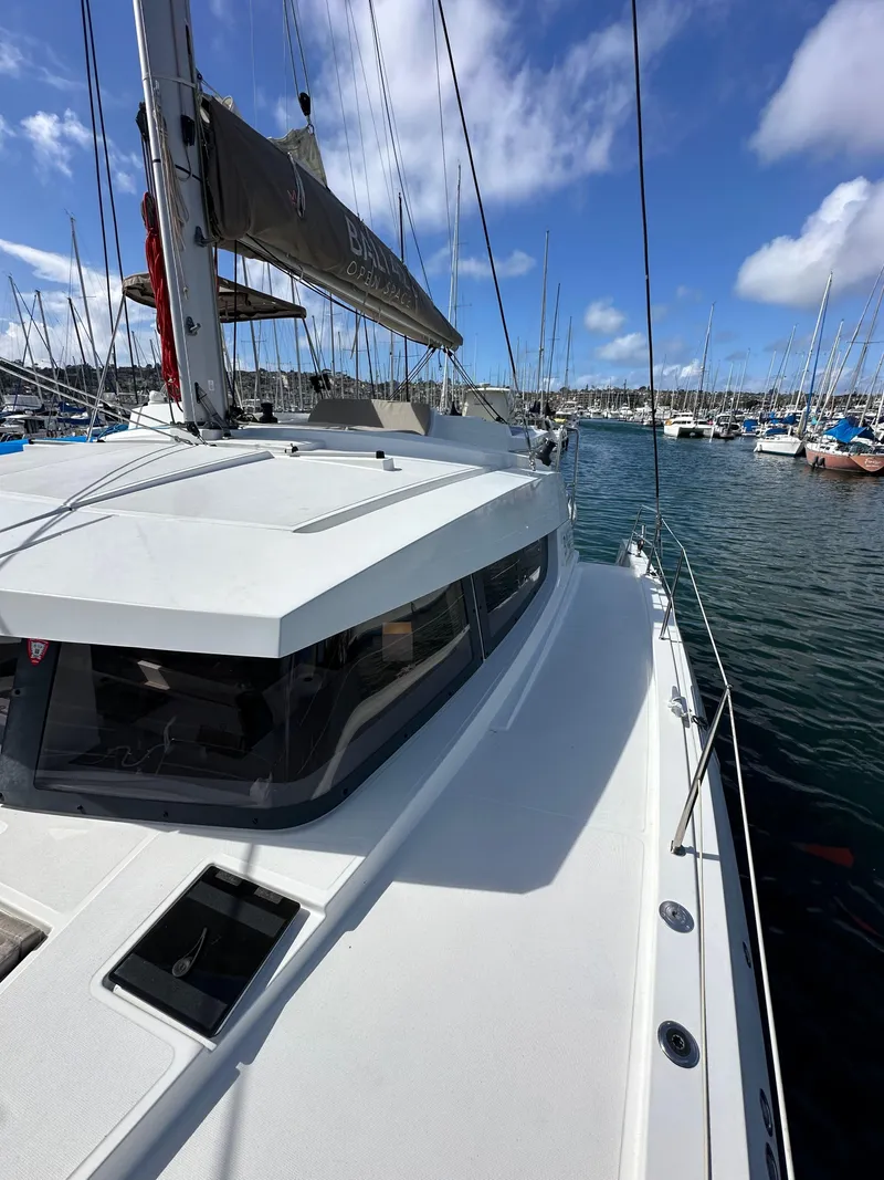 Slide: The Image of 2023 Bali 4.2 yacht docked in a marina under a clear blue sky. - 31