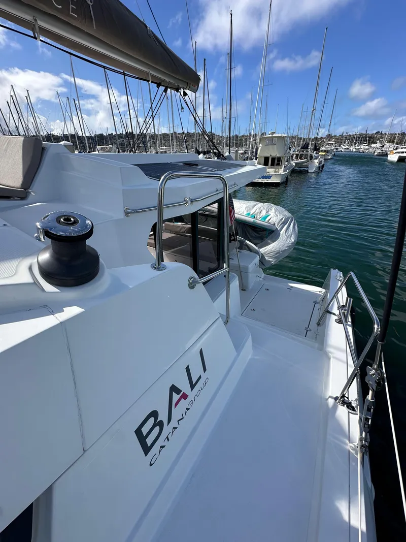 Slide: The Image of 2023 Bali 4.2 catamaran docked in marina, clear sky, calm water. - 32