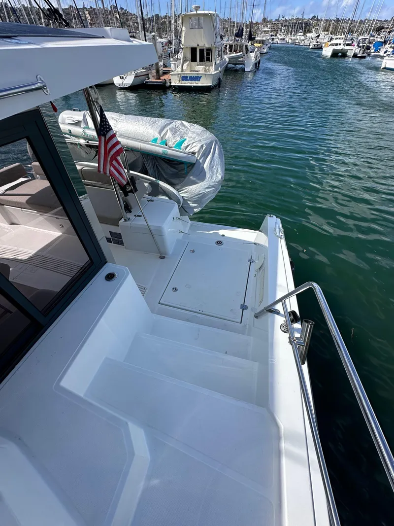 Slide: The Image of 2023 Bali 4.2 yacht docked in marina, rear view with American flag. - 34