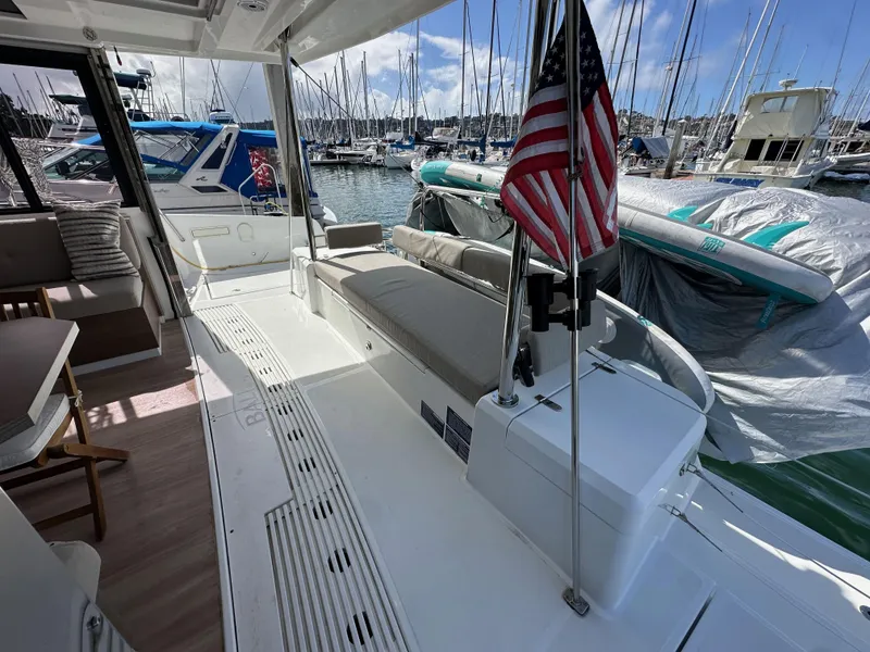 Slide: The Image of Bali 4.2 yacht interior with American flag, docked at marina, 2023 model. - 35
