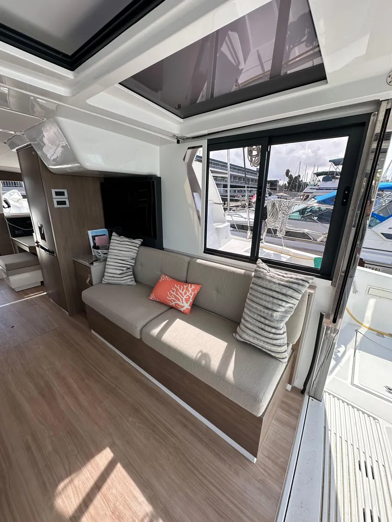Slide: The Image of Interior of 2023 Bali 4.2 yacht, featuring modern seating and large windows. - 39